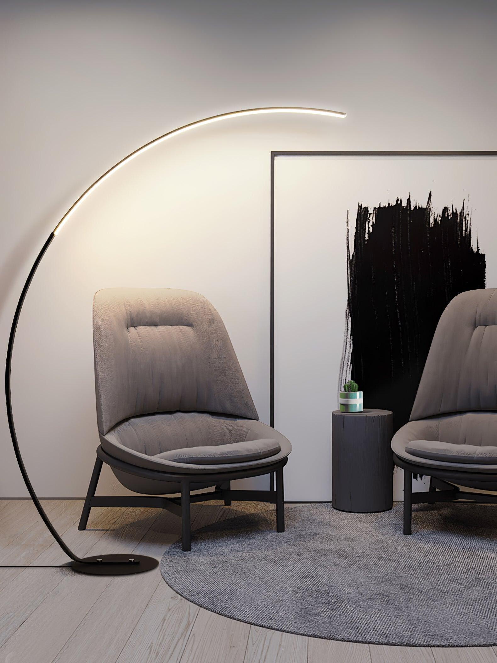 Black arc lamp beside two lounge chairs