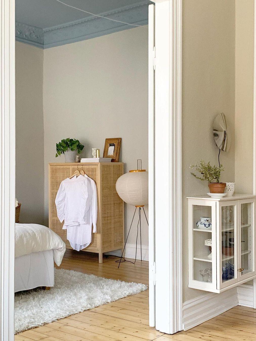Paper floor lamp near bedroom shelving