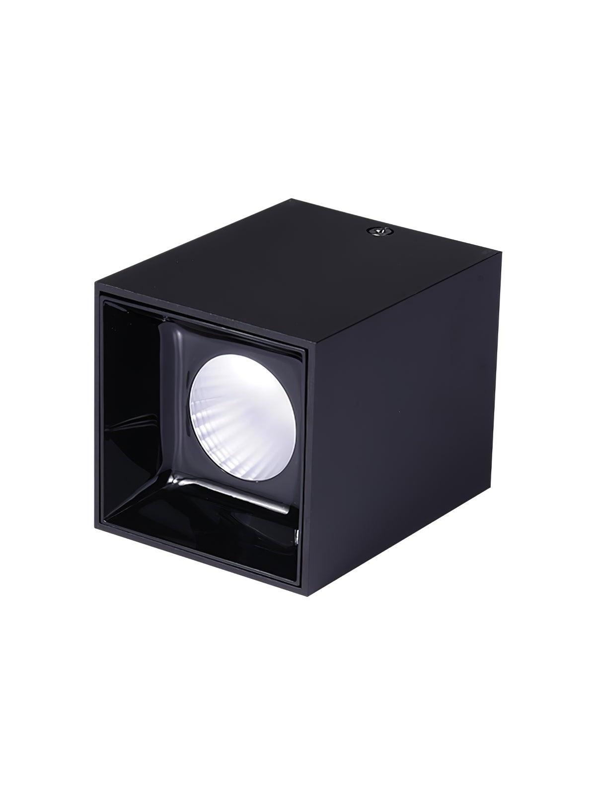 Isolated black spotlight on its side, with a circular reflector, glossy square recess and side screw