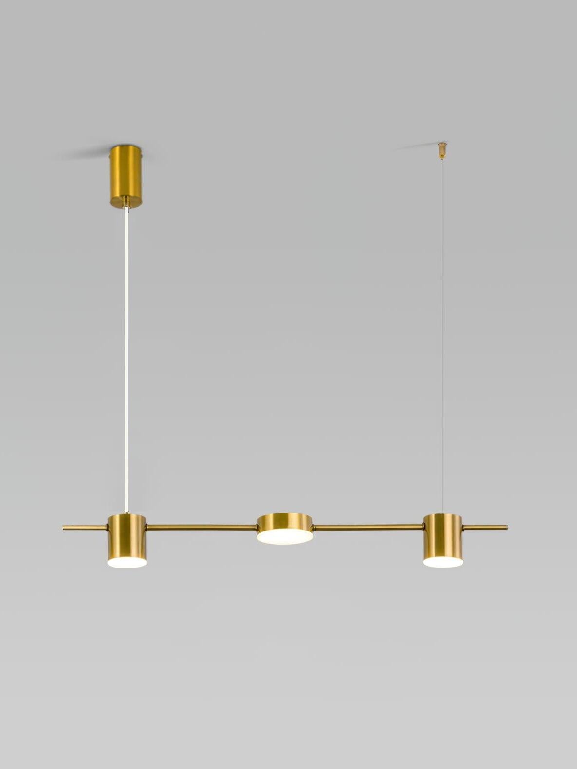 70 cm gold linear pendant with two cylinders flanking a shallow disc