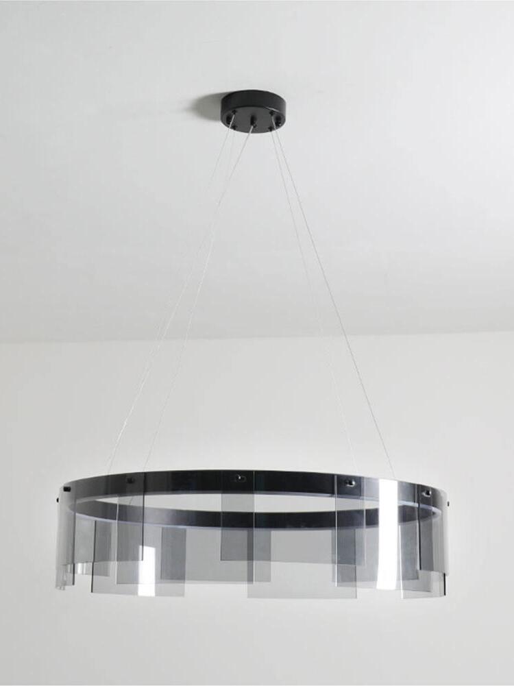 Suspended Stratos chandelier with curved glass panels below a black ring