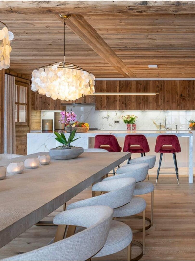 Two shell fixtures in a wood-lined dining room