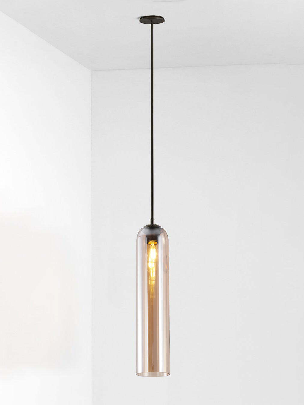 Amber glass Long Tube pendant with black rod and canopy, showing a long illuminated bulb inside the transparent shade