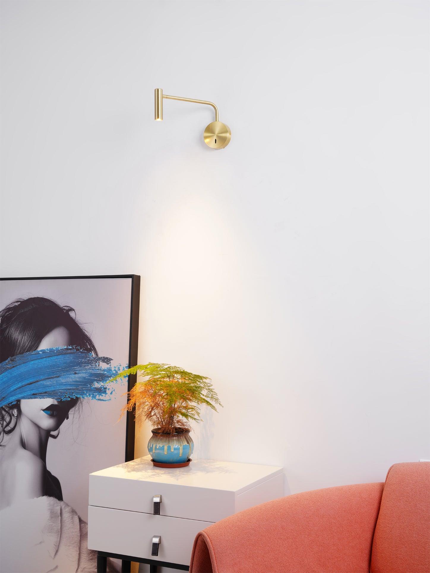 Gold-coloured reading head lit near a reading chair