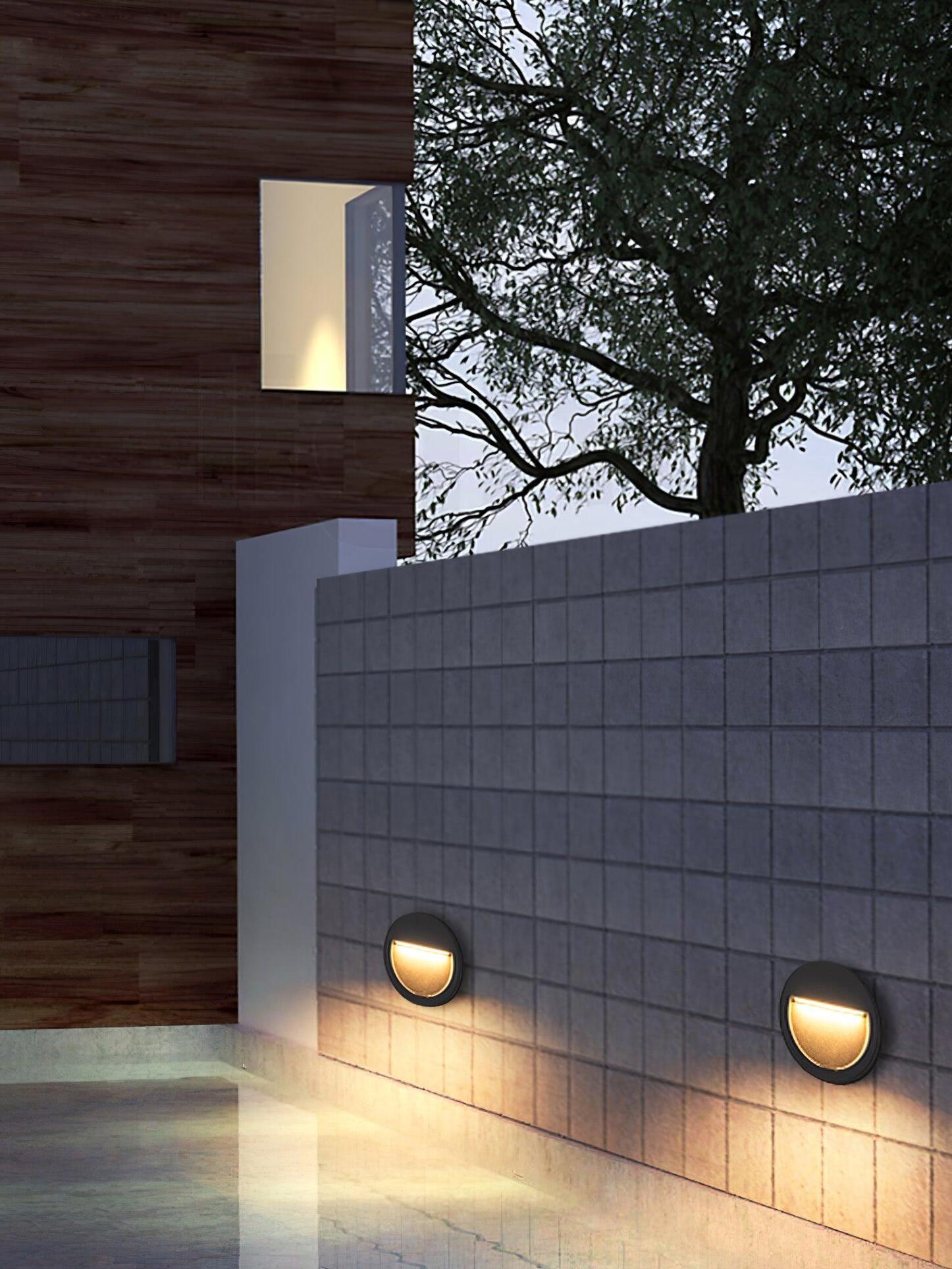 Two small wall lights along garden boundary