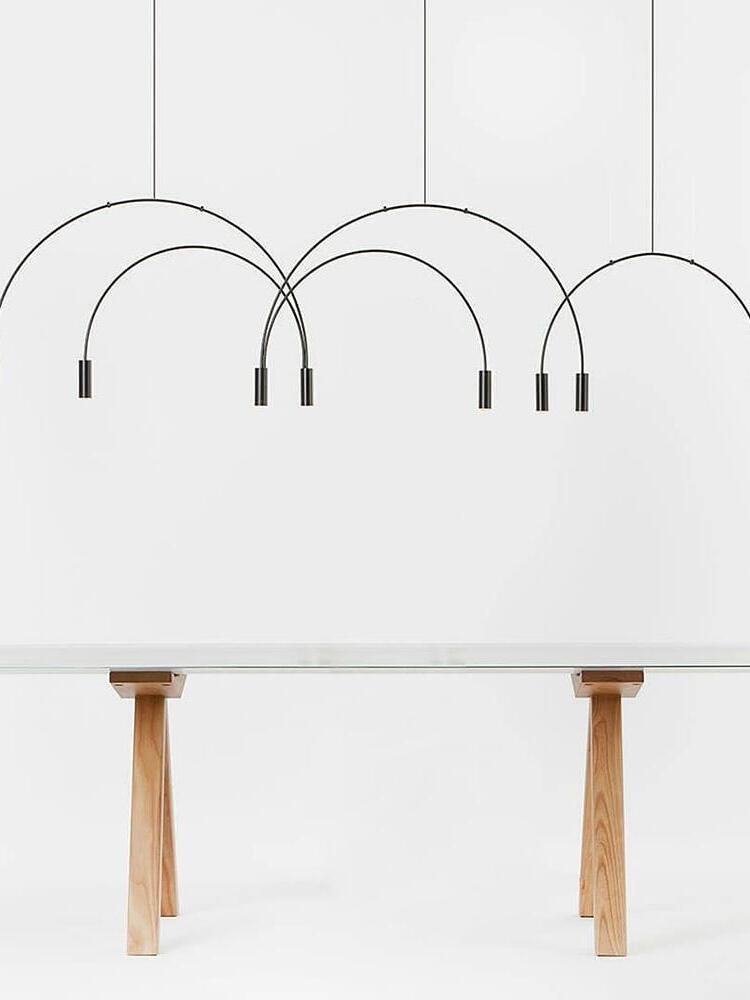 Black arch pendant against a light wall