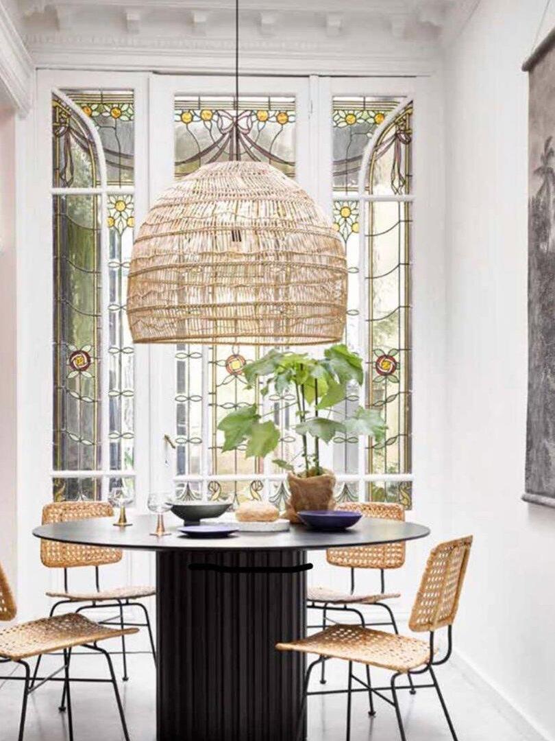 Natural basket pendant above a window-side table