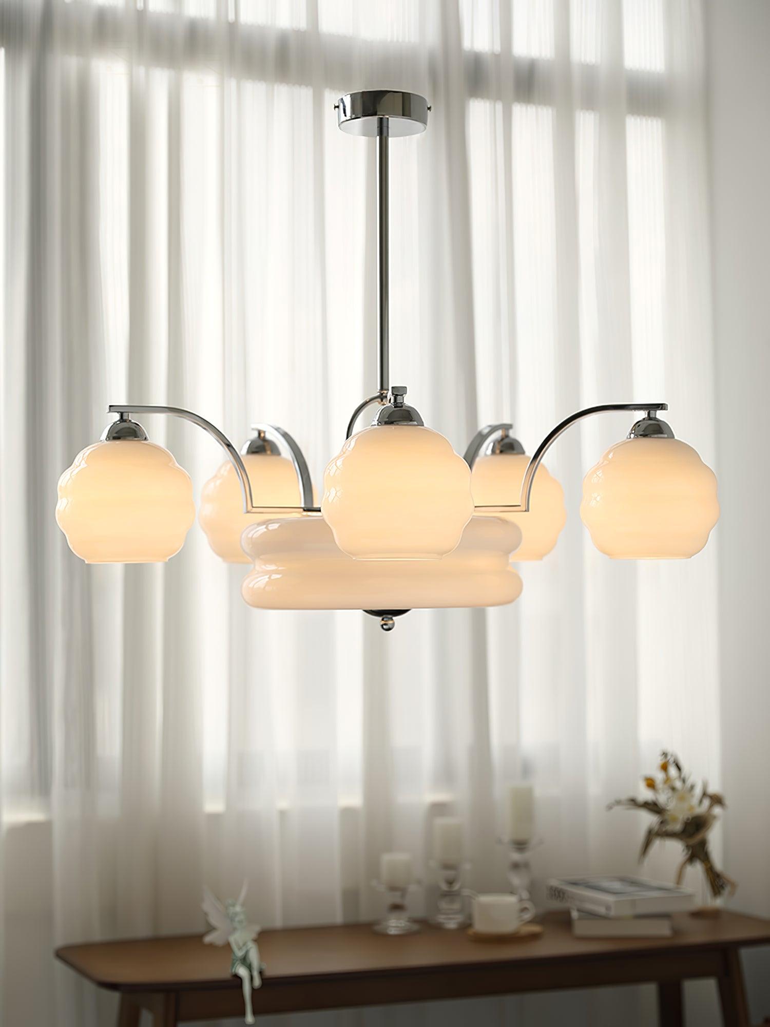 Chrome chandelier in front of sheer curtains