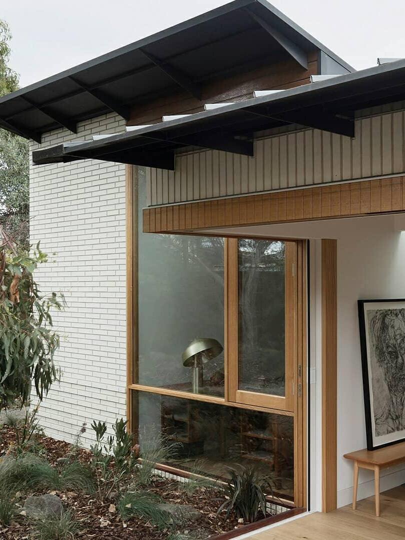 Building exterior with lamp visible inside window