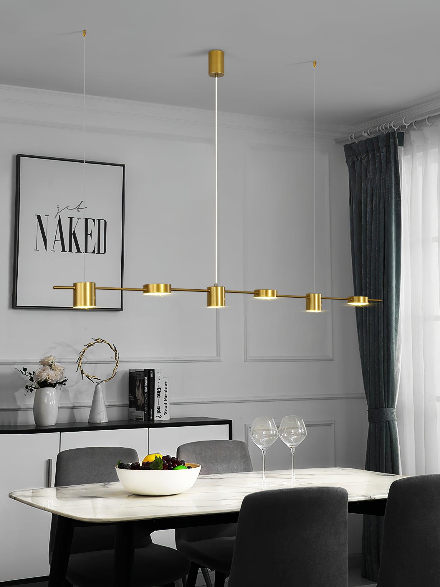Gold linear pendant above a round dining table