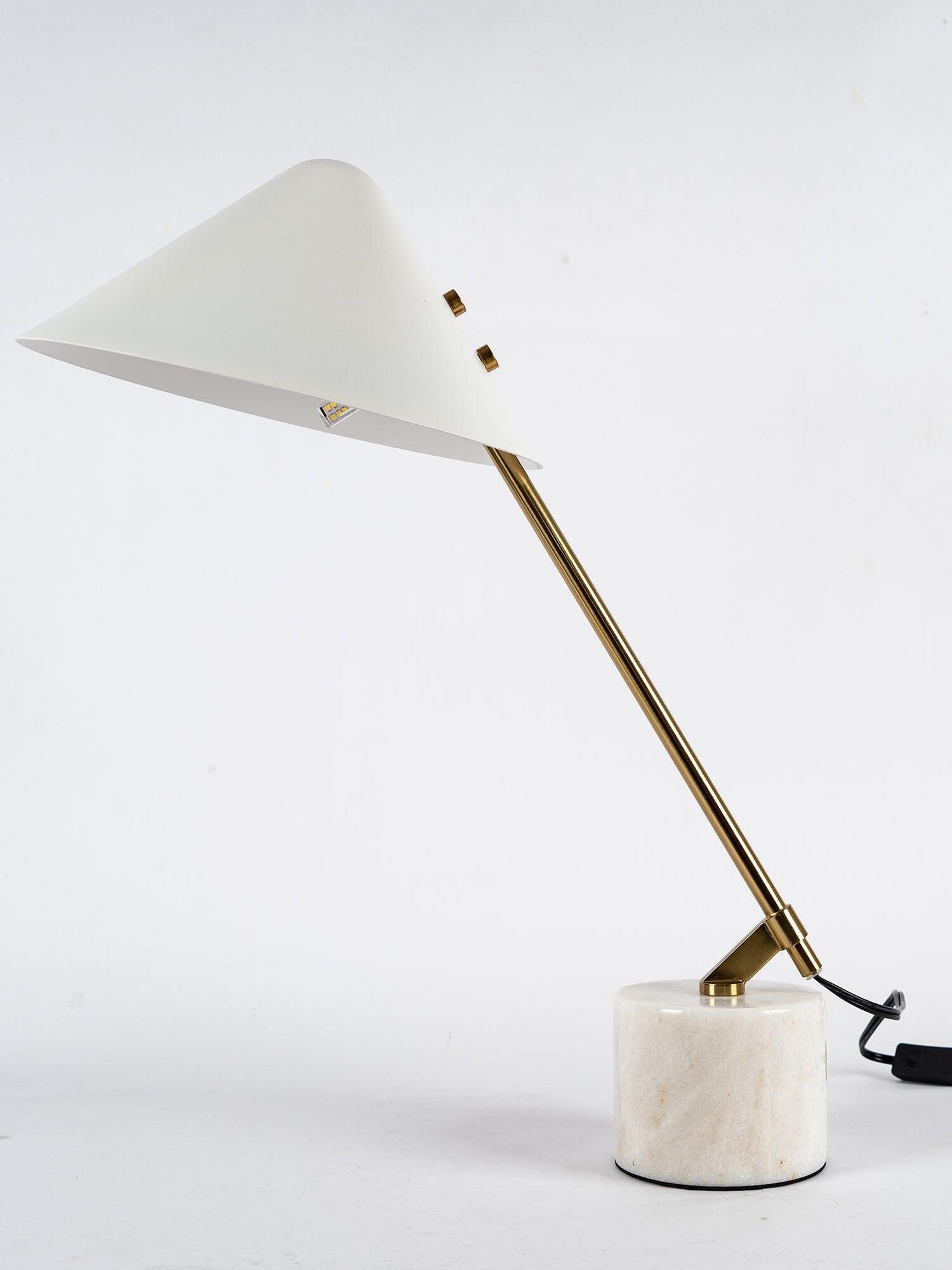 White shade with gold-tone side fittings and arm, pale patterned cylinder base and black cord