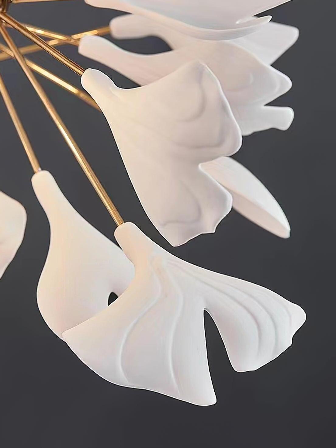 White ceramic fan-shaped leaves with curved lobes and vein relief