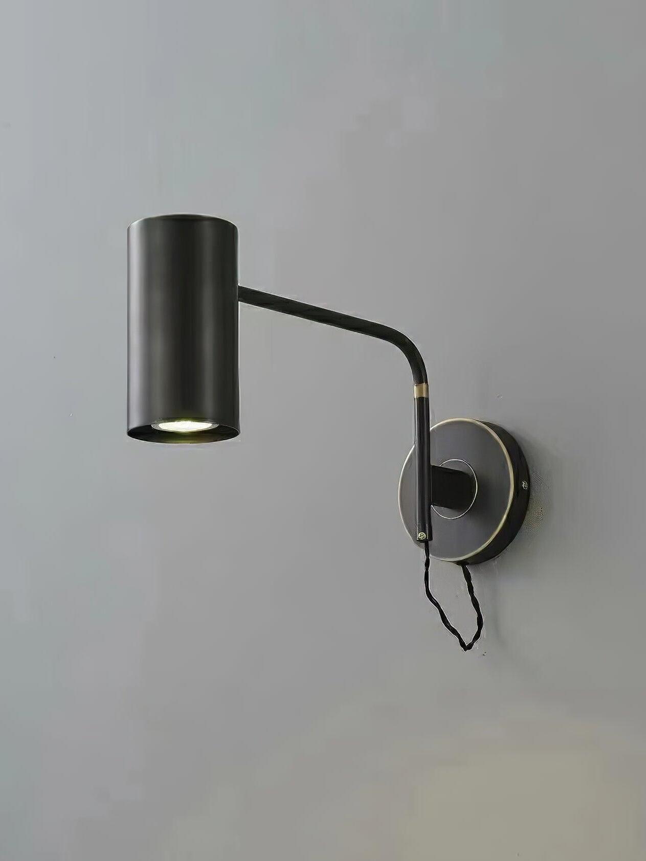 Black cylindrical wall light angled from plate with looped cable