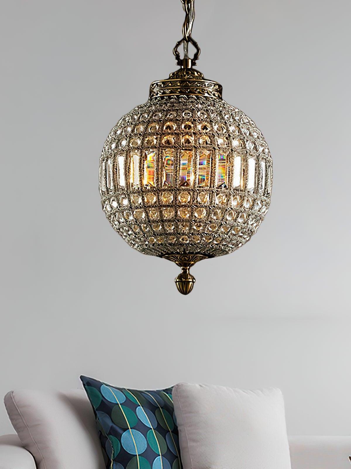 Single glowing crystal globe above a pale armchair with a patterned cushion against a gray wall