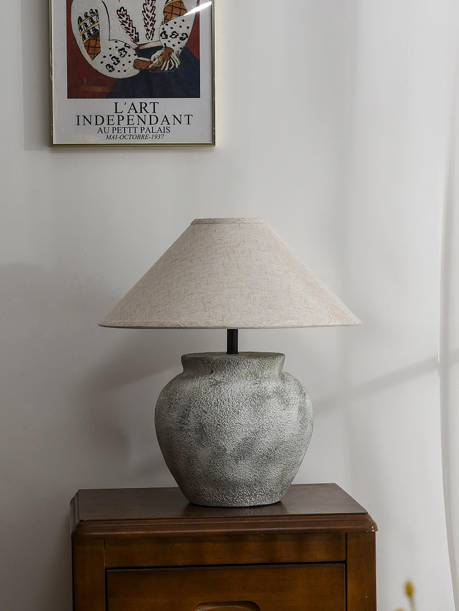 Unlit urn lamp on dark wooden cabinet