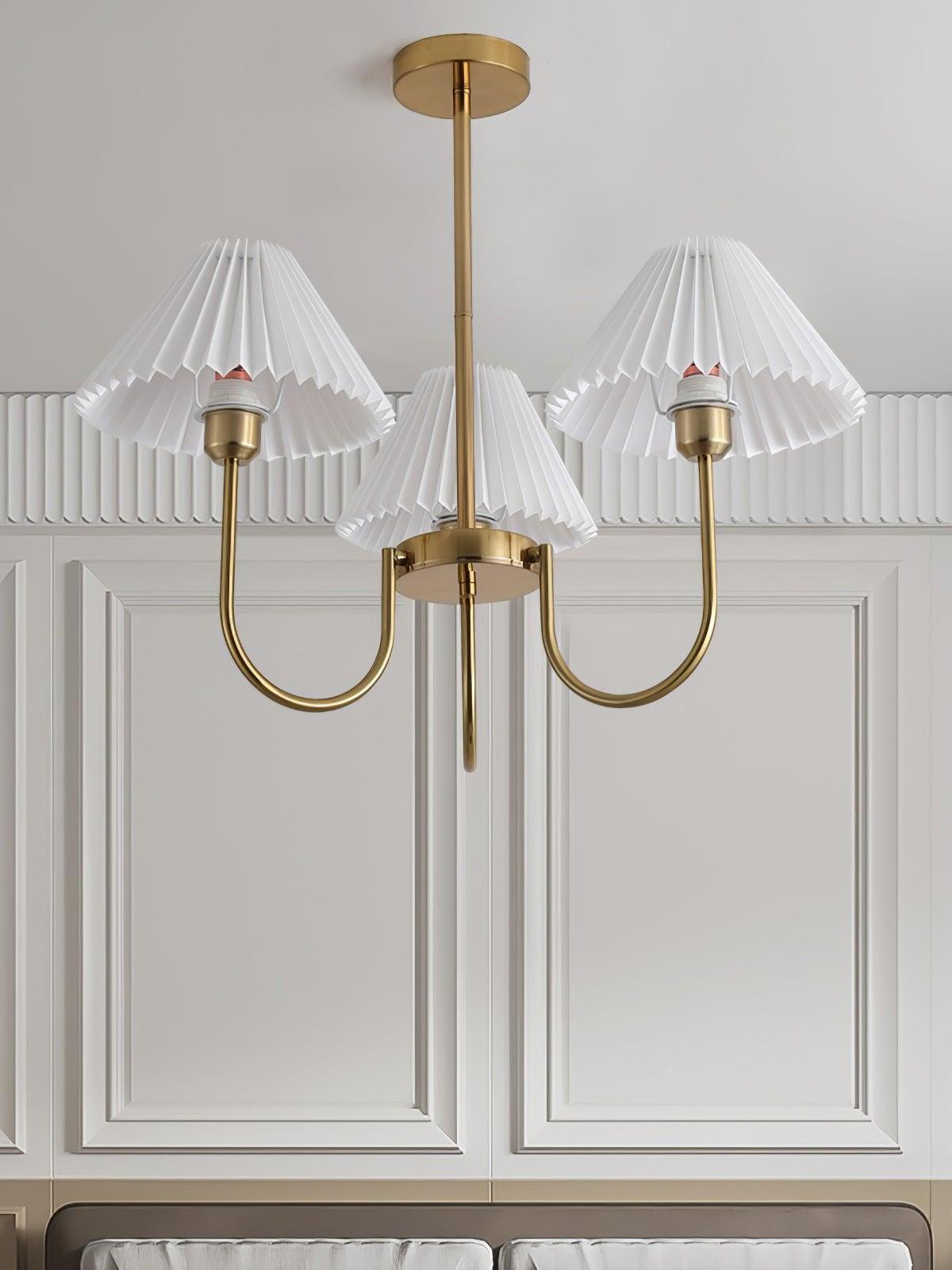 Three-shade Lenore chandelier in front of white decorative wall panels