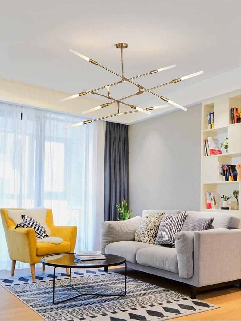 Horizontal Gold chandelier above a grey sofa
