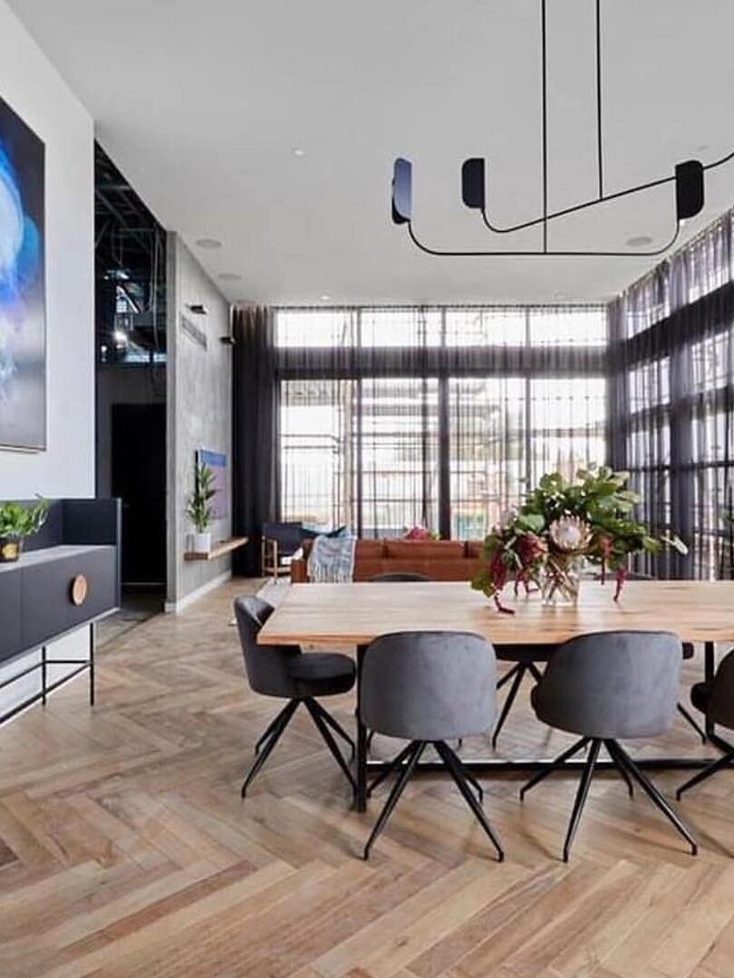 Black curved arms over a bright dining area