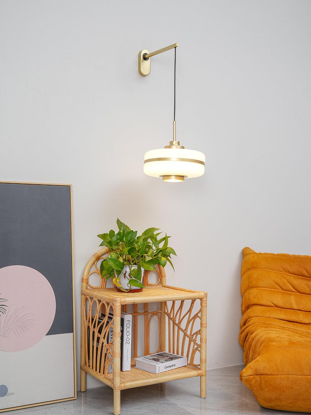 Masina wall arm and lit shade beside yellow chair and wicker stand