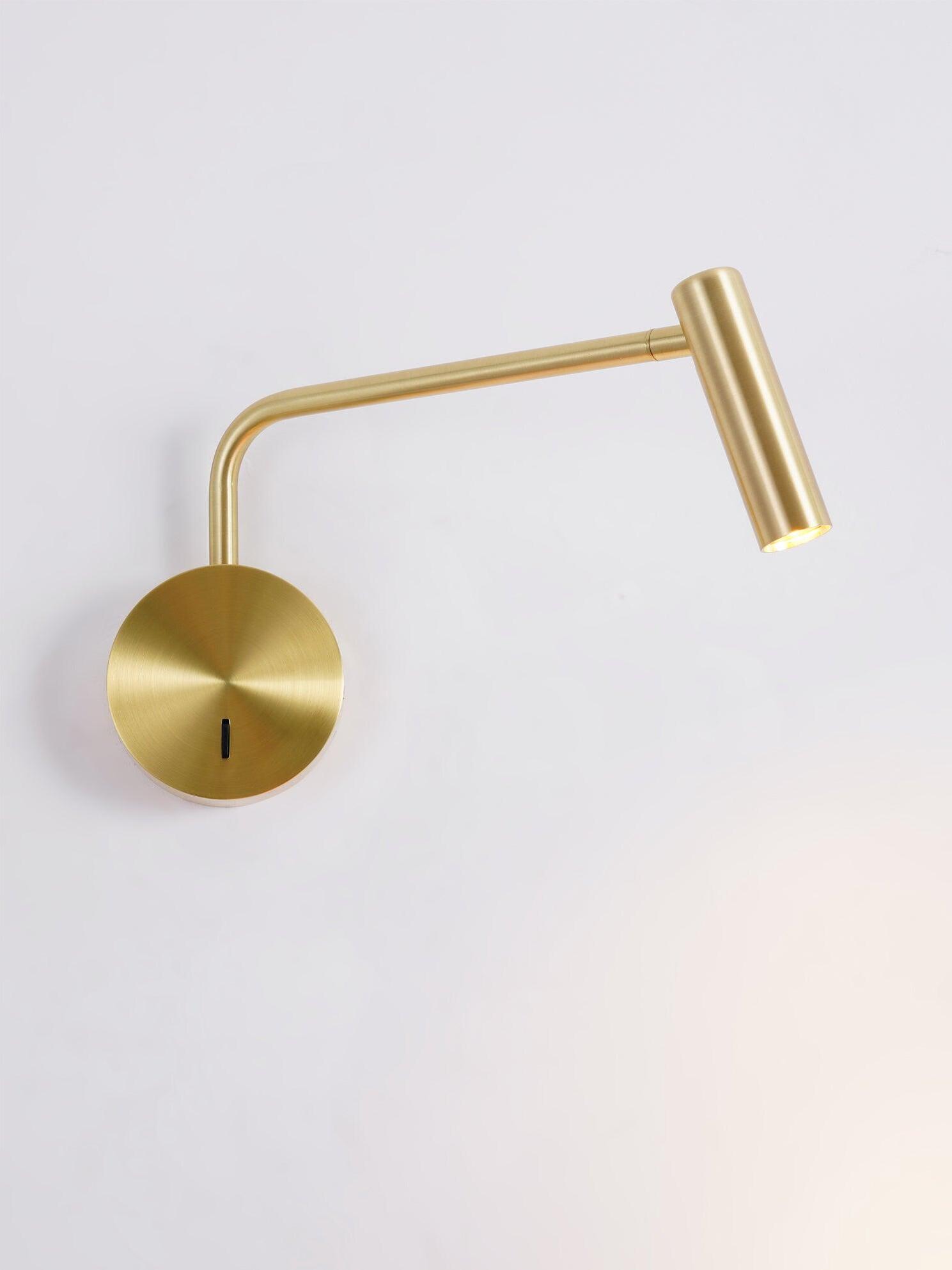 Gold-coloured sconce with angled cylindrical head