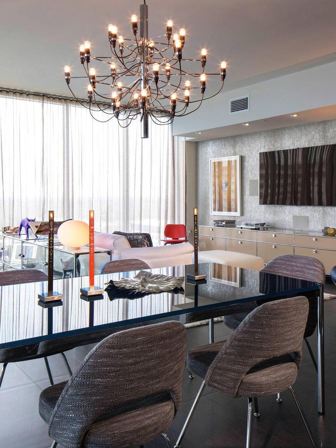 Illuminated exposed-bulb chandelier in a dining area