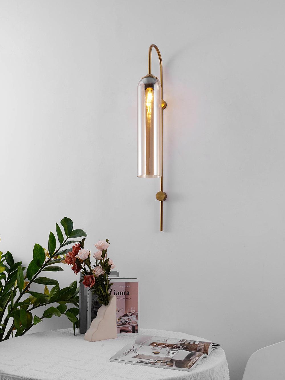 Amber-tinted cylindrical shade beside flowers