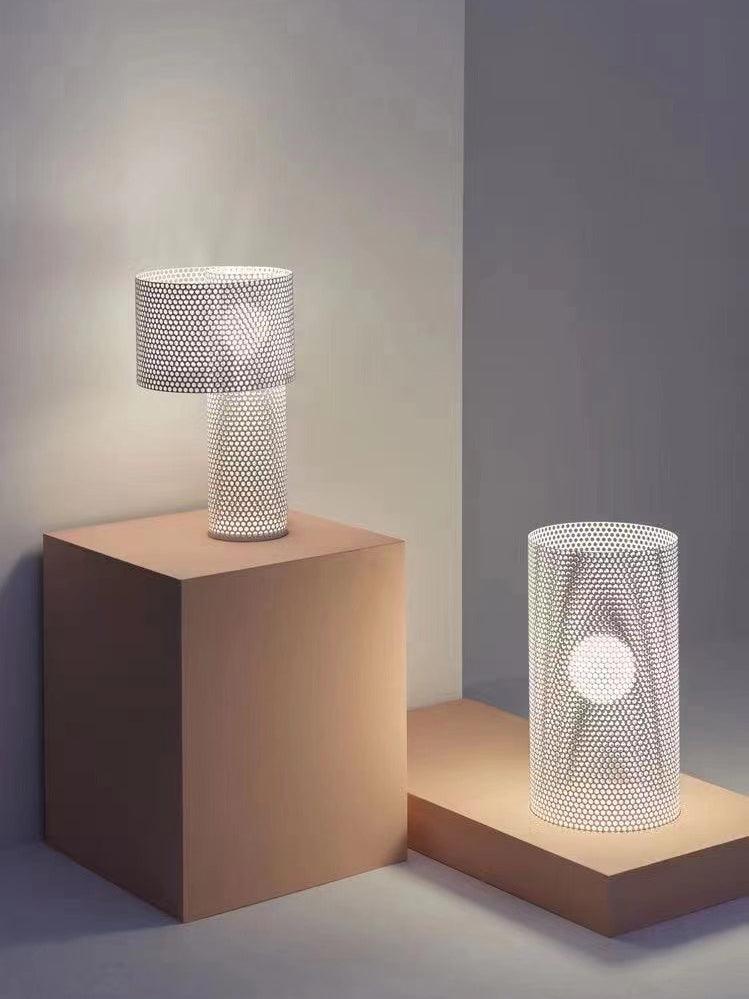 Embrey lamp on plinth beside a separate cylinder lamp