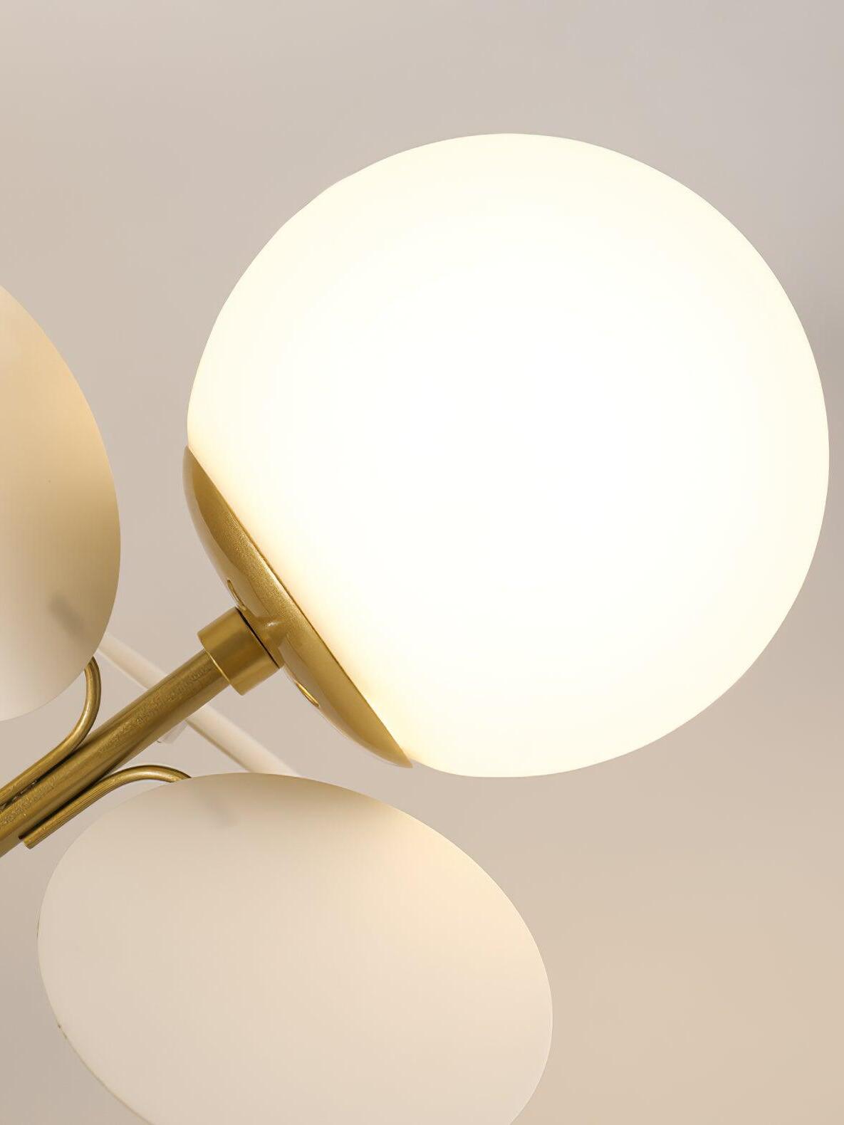 Close view of White globe diffuser on a Gold fitting