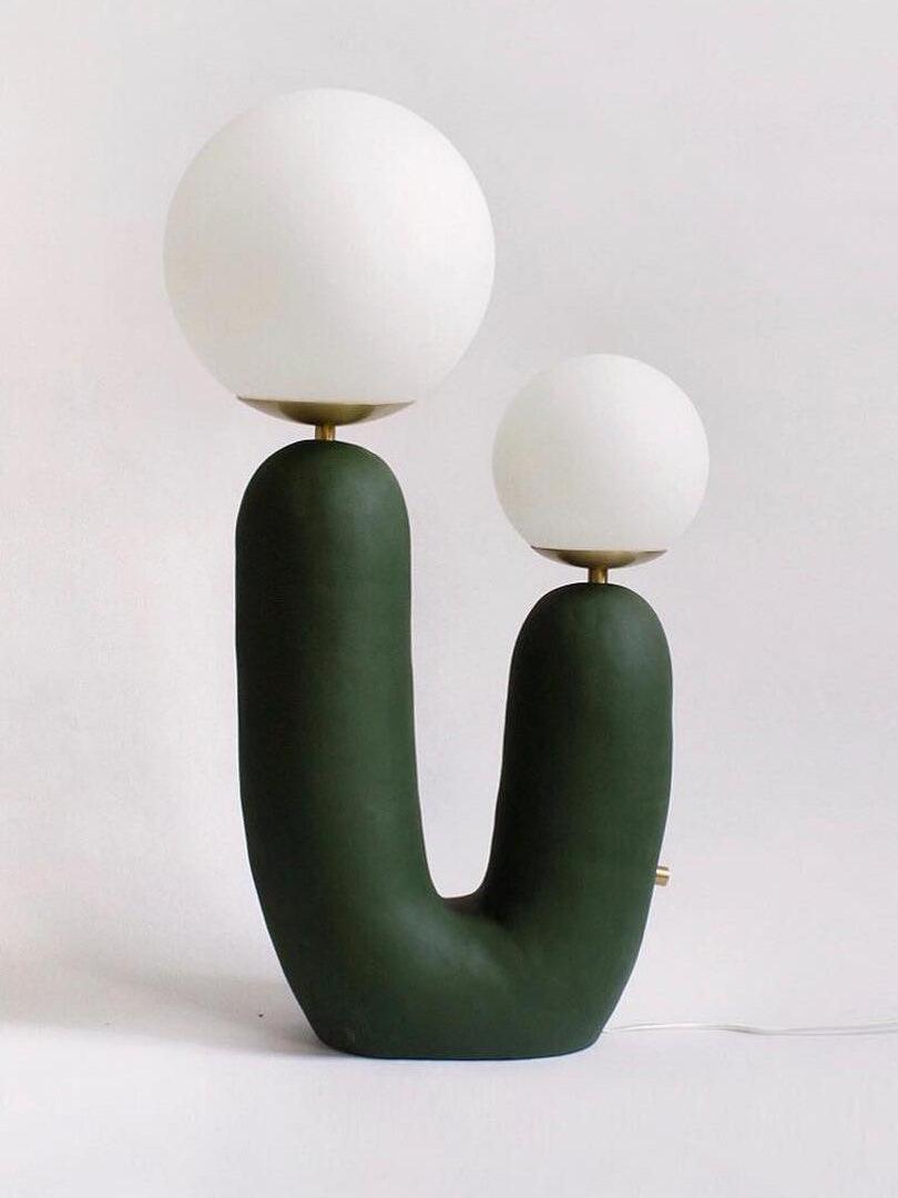 Green Oo Rough lamp with larger left and smaller right opal globe, textured U-shaped body, side control and cord