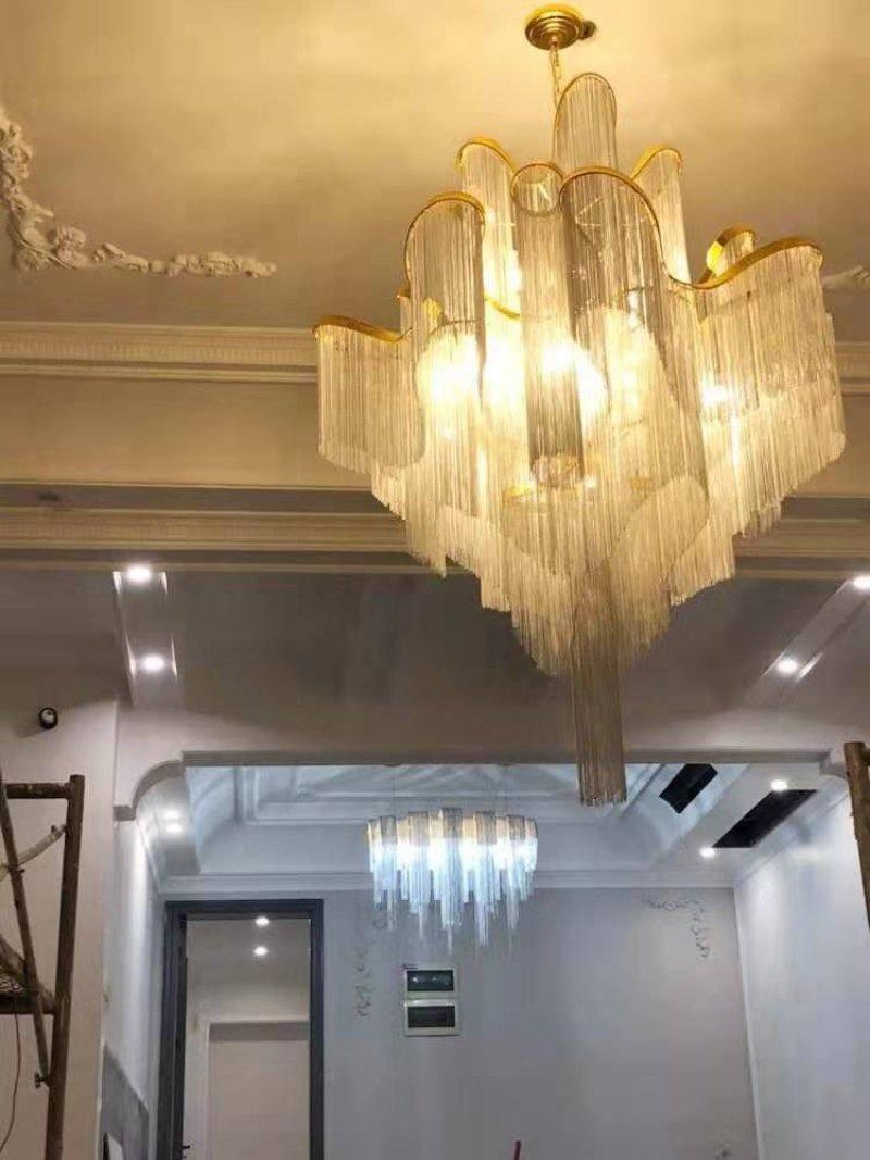 Gold and pale chain strands below a ceiling canopy