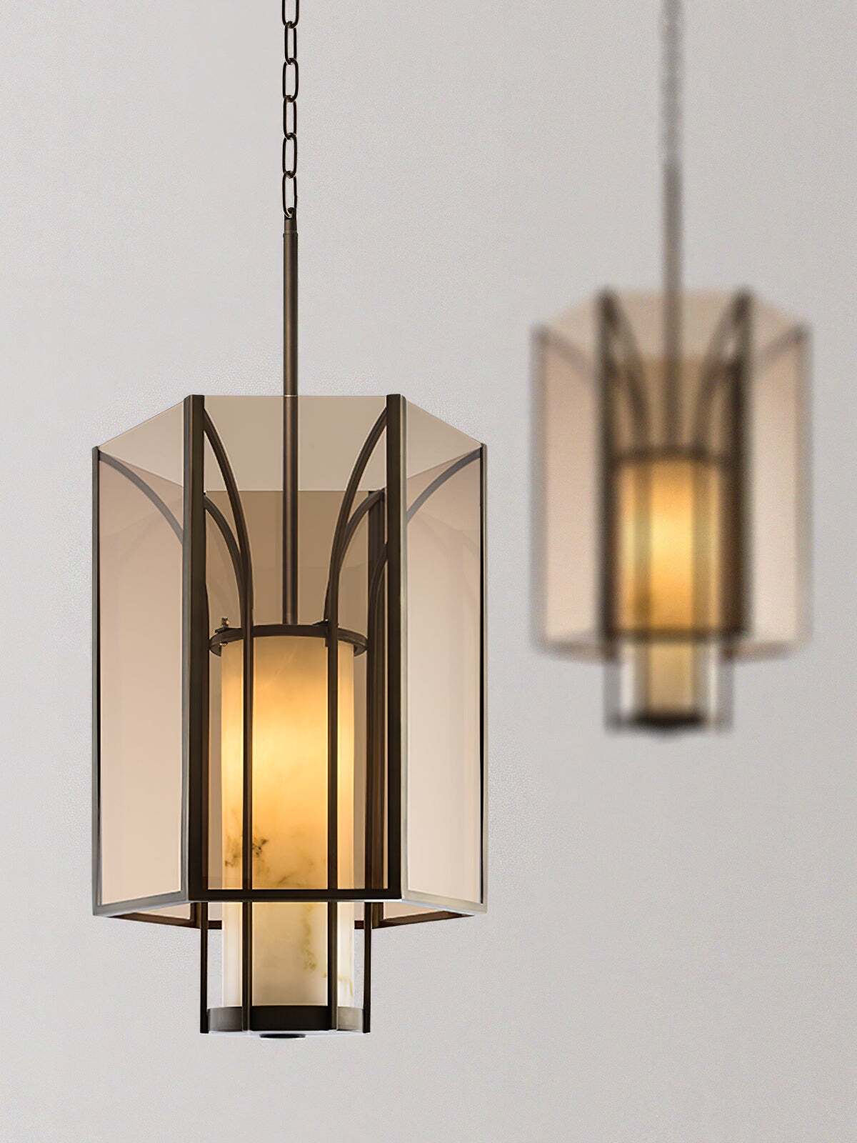 Foreground amber lantern pendant with second lamp behind