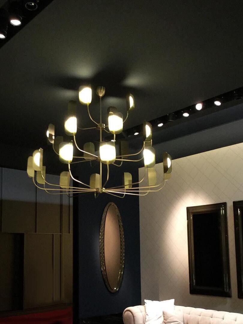 Illuminated tiered LEAF chandelier in a dark interior