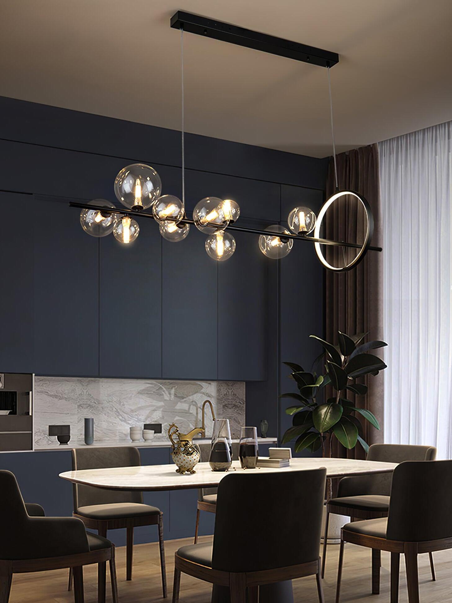 Black linear chandelier above a dark dining area