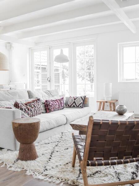 Rattan pendant above a sofa and woven chairs