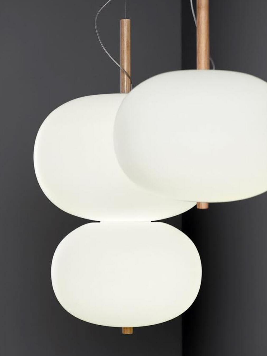 Close view of white glass globes and wood stems