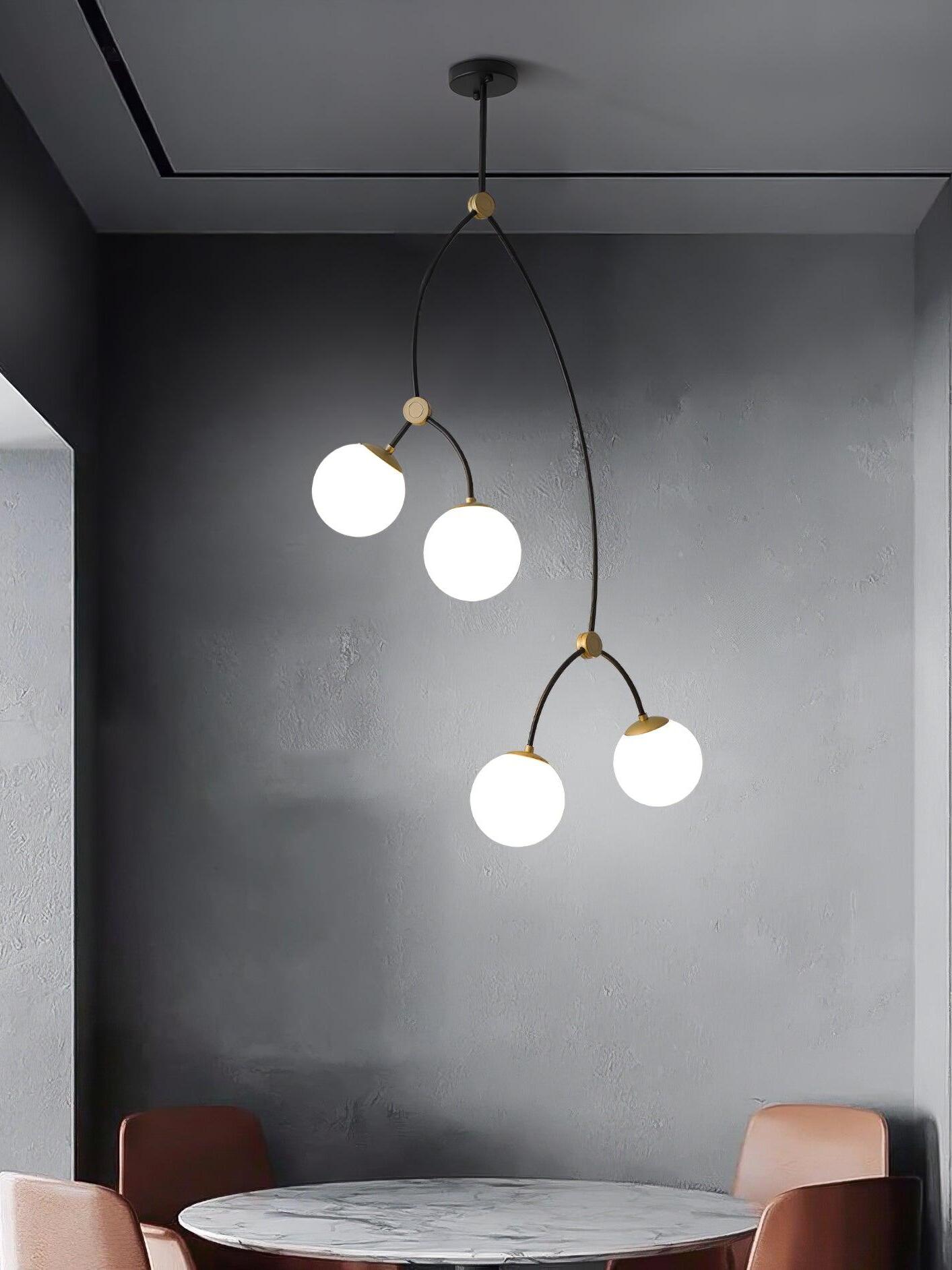Tall white four-globe chandelier against a dark wall