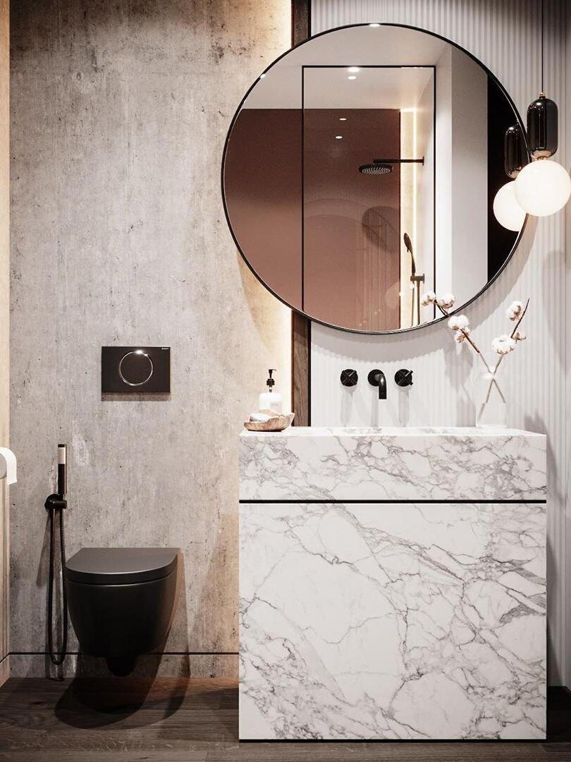 Globe pendant beside a round mirror in a bathroom scene