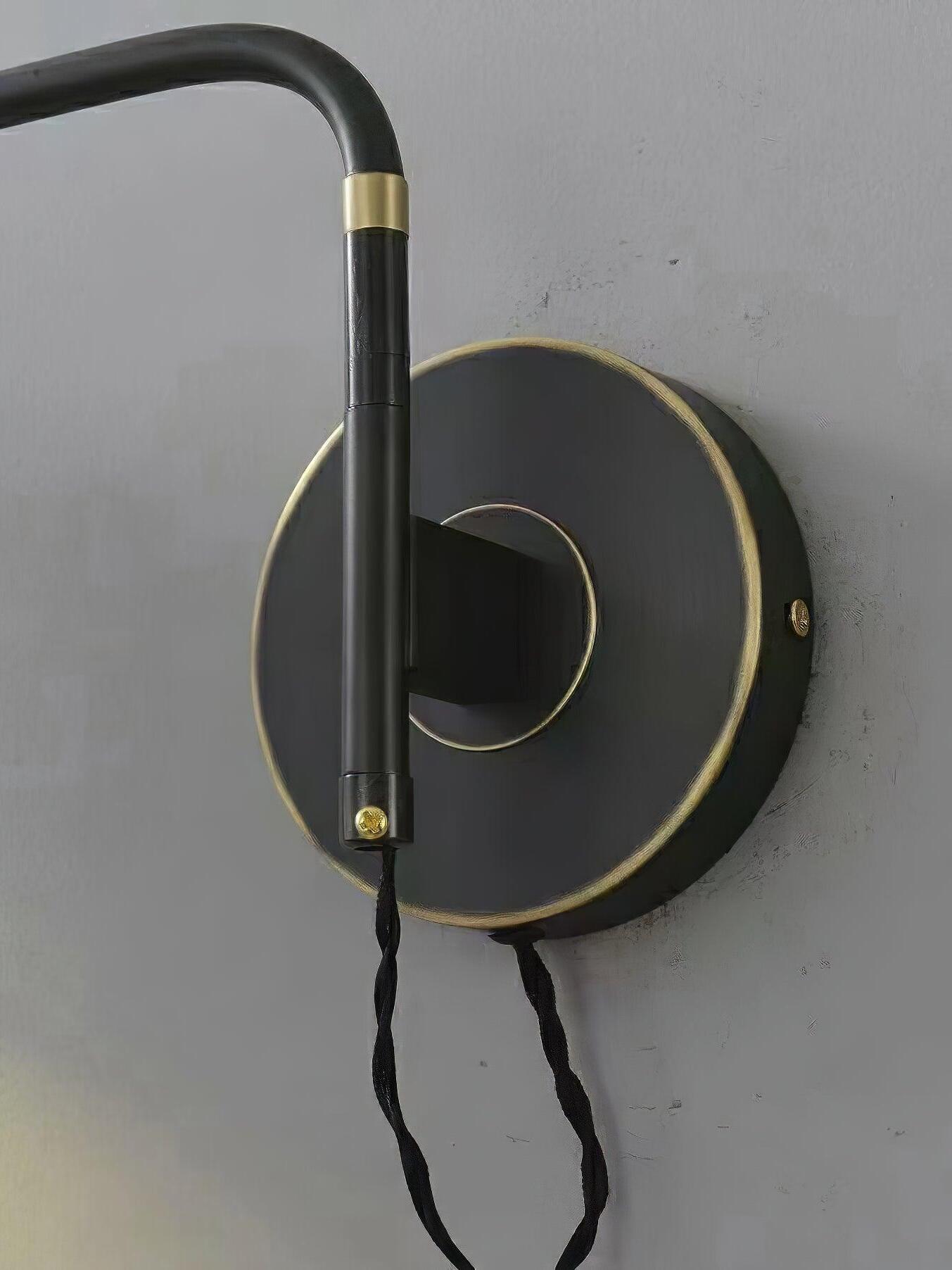 Black round plate with gold-tone rim and vertical arm joint