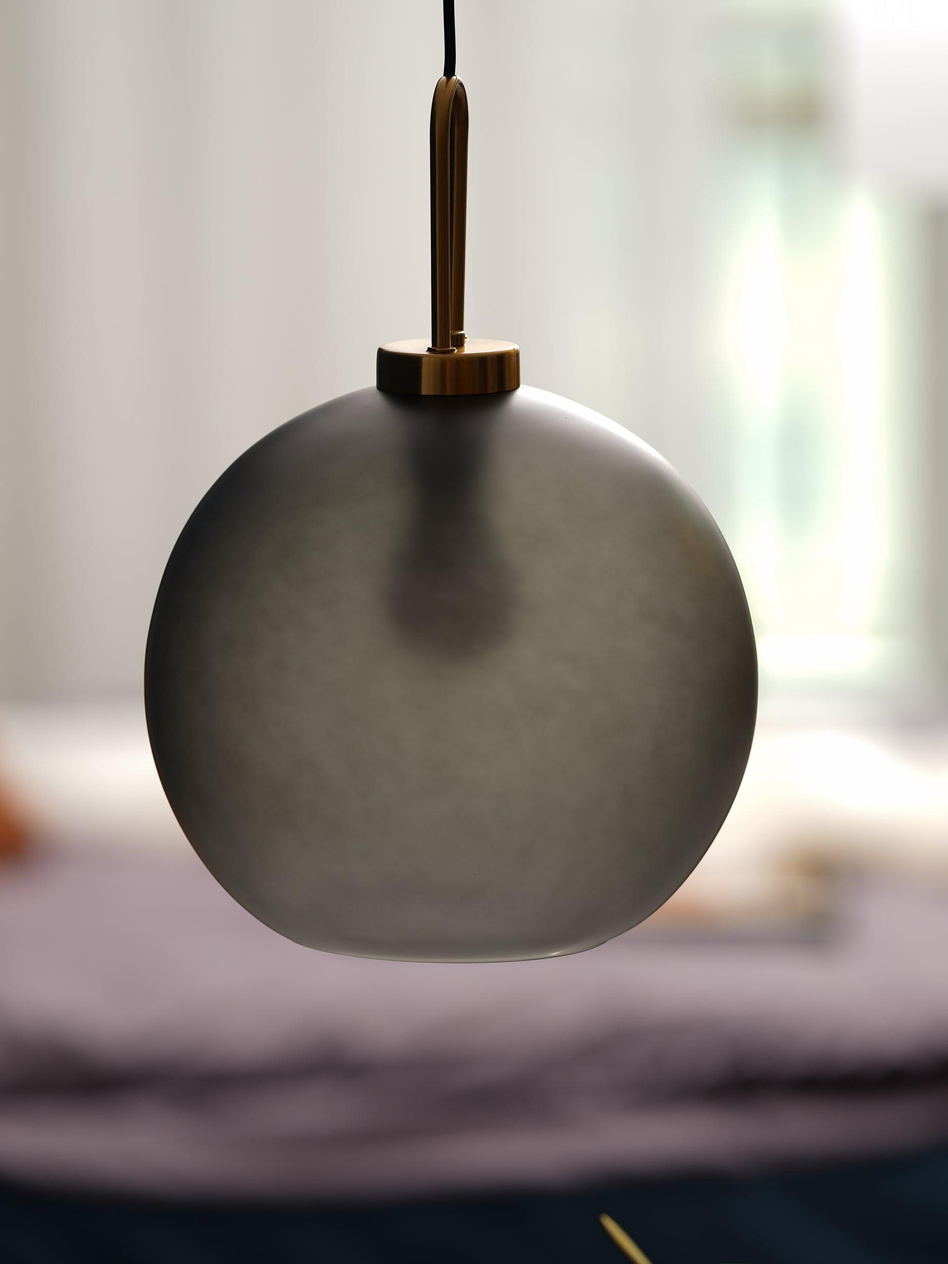 Close-up of smoky frosted glass and top fitting