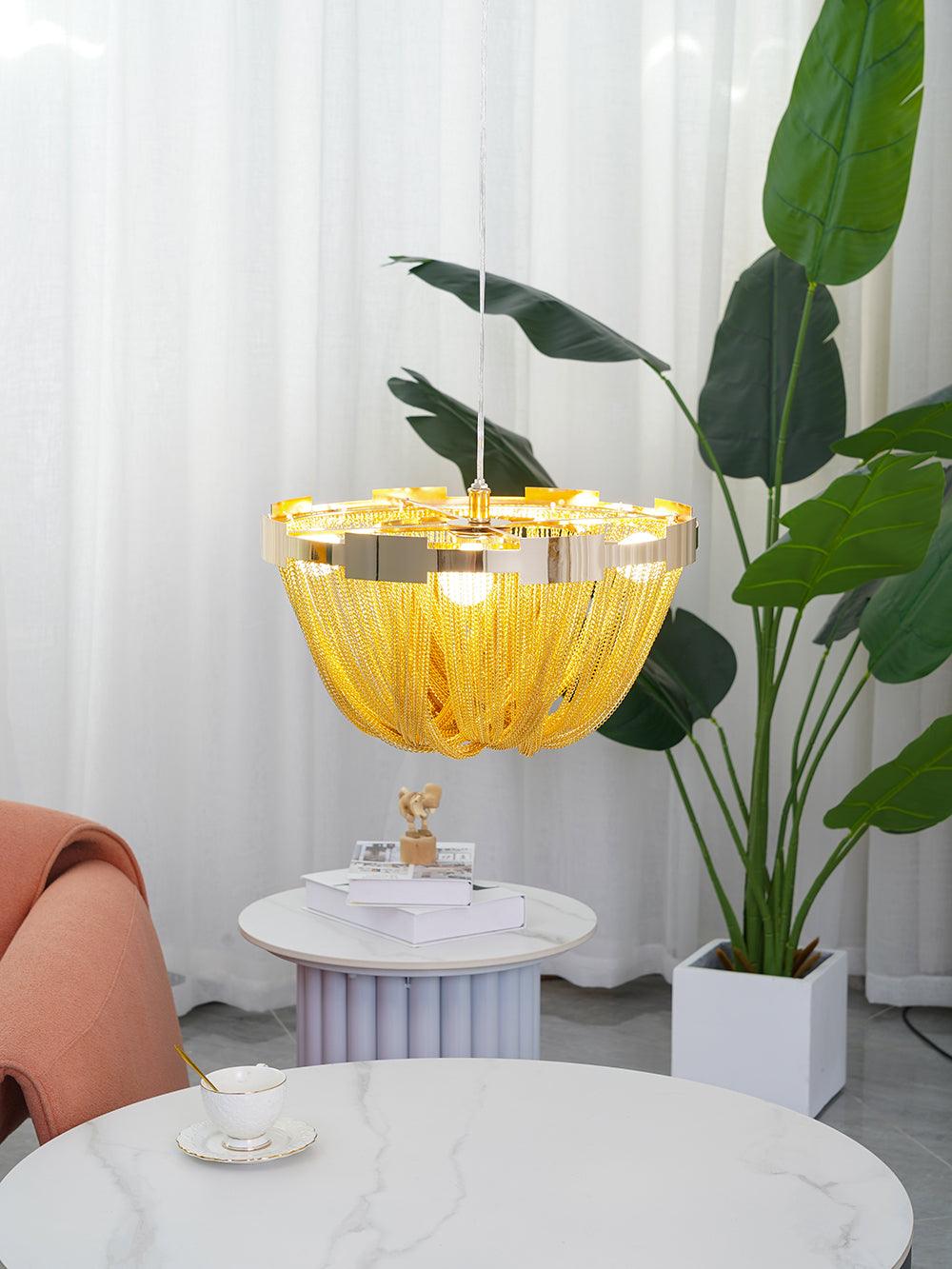 Gold-tone chain ceiling light beside leafy indoor plant