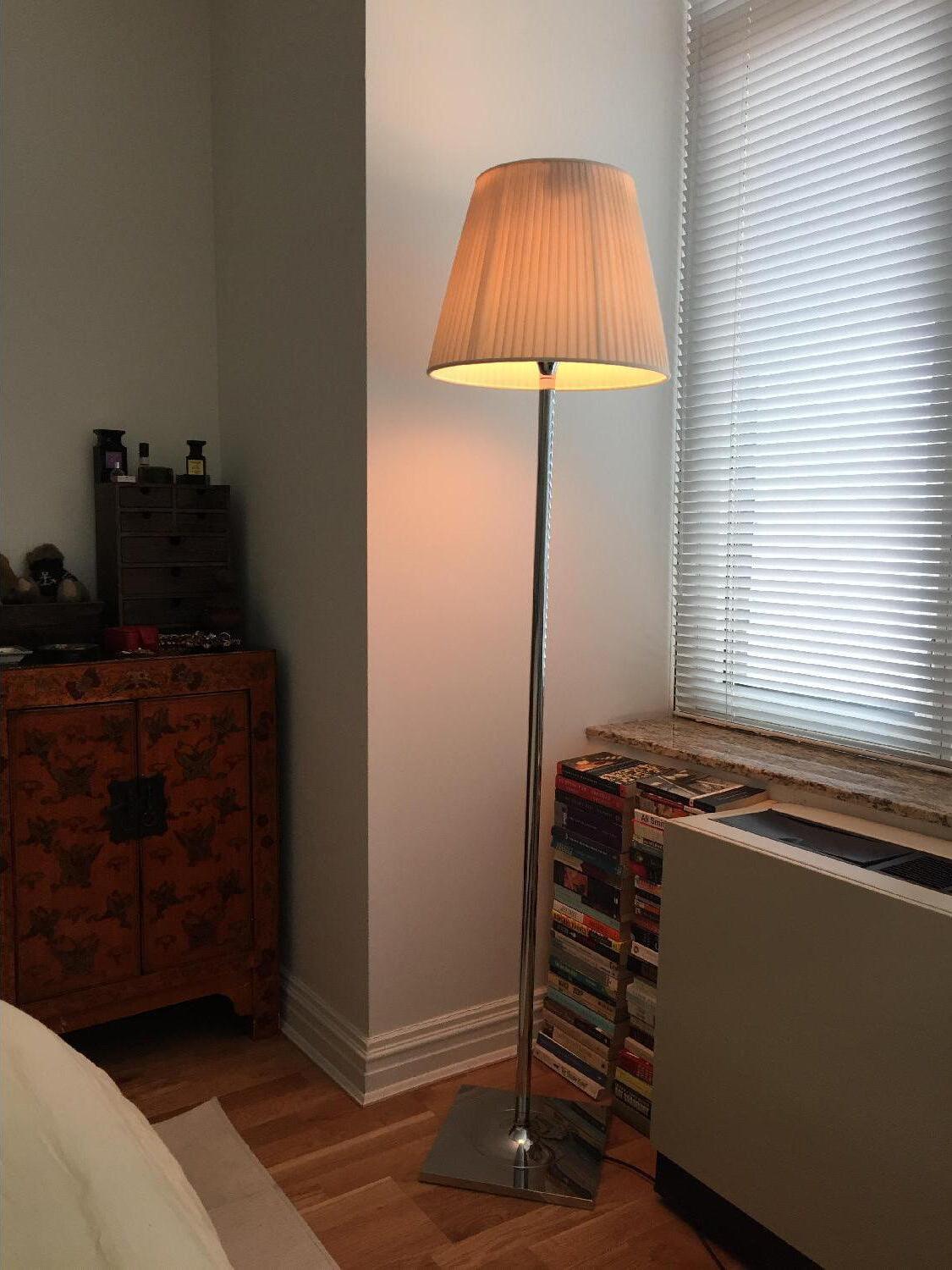 Ktribe floor lamp photographed with a warm glow beside a bed