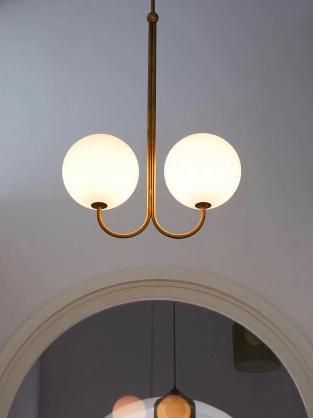 Two Opal globes on a Brass U-shaped frame