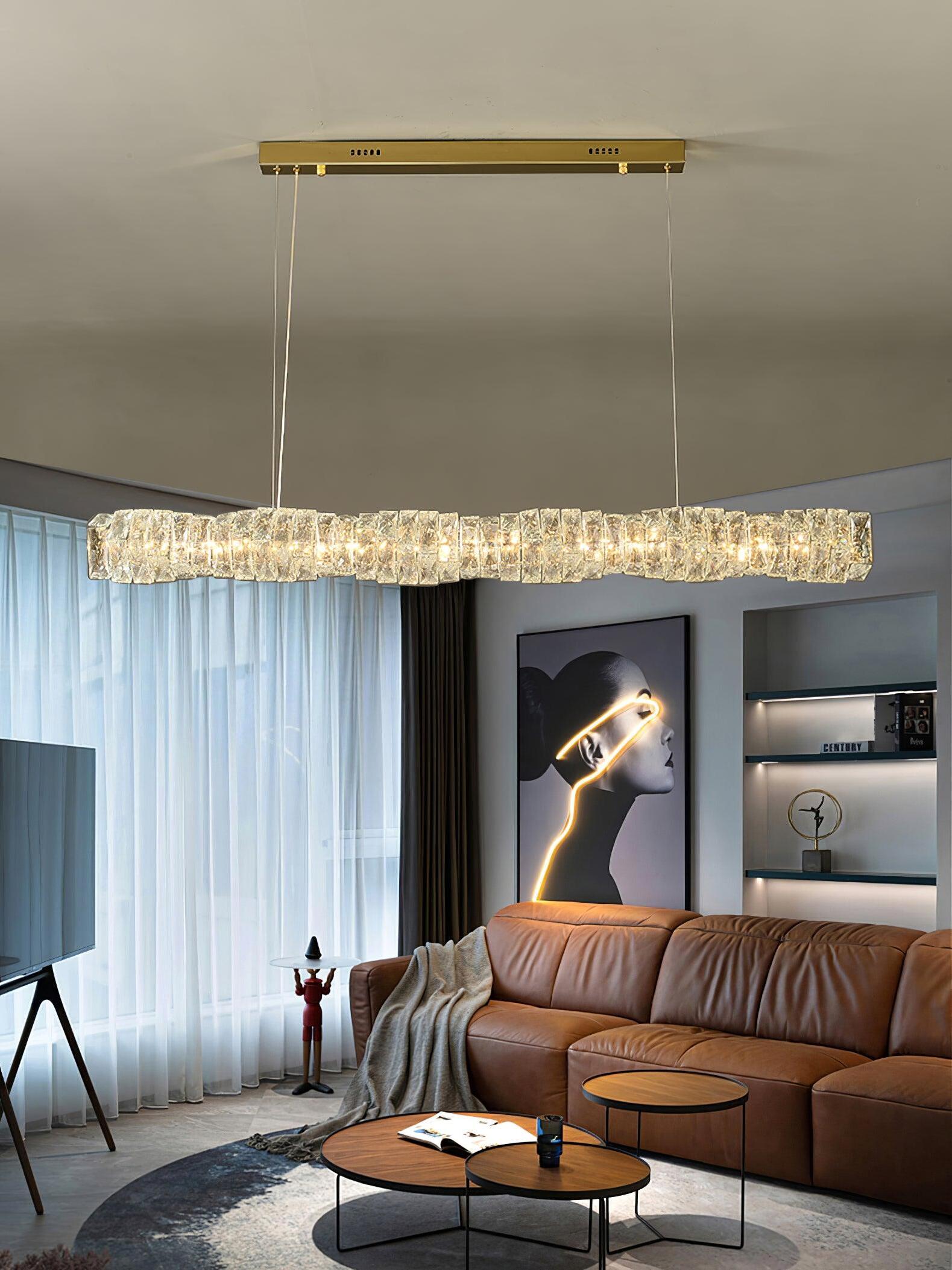 Gold canopy and crystal bar above a brown sofa near a window with sheer curtains