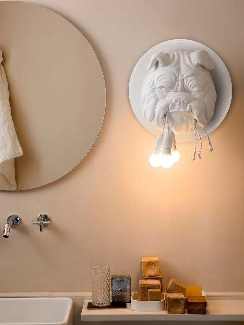 White bulldog wall light above a washbasin in a room scene