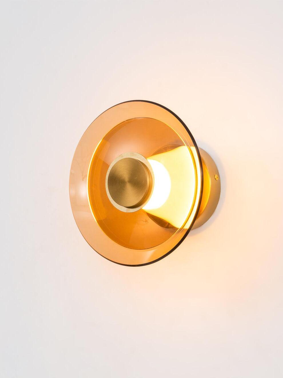 Glowing amber glass wall disc and raised gold centre