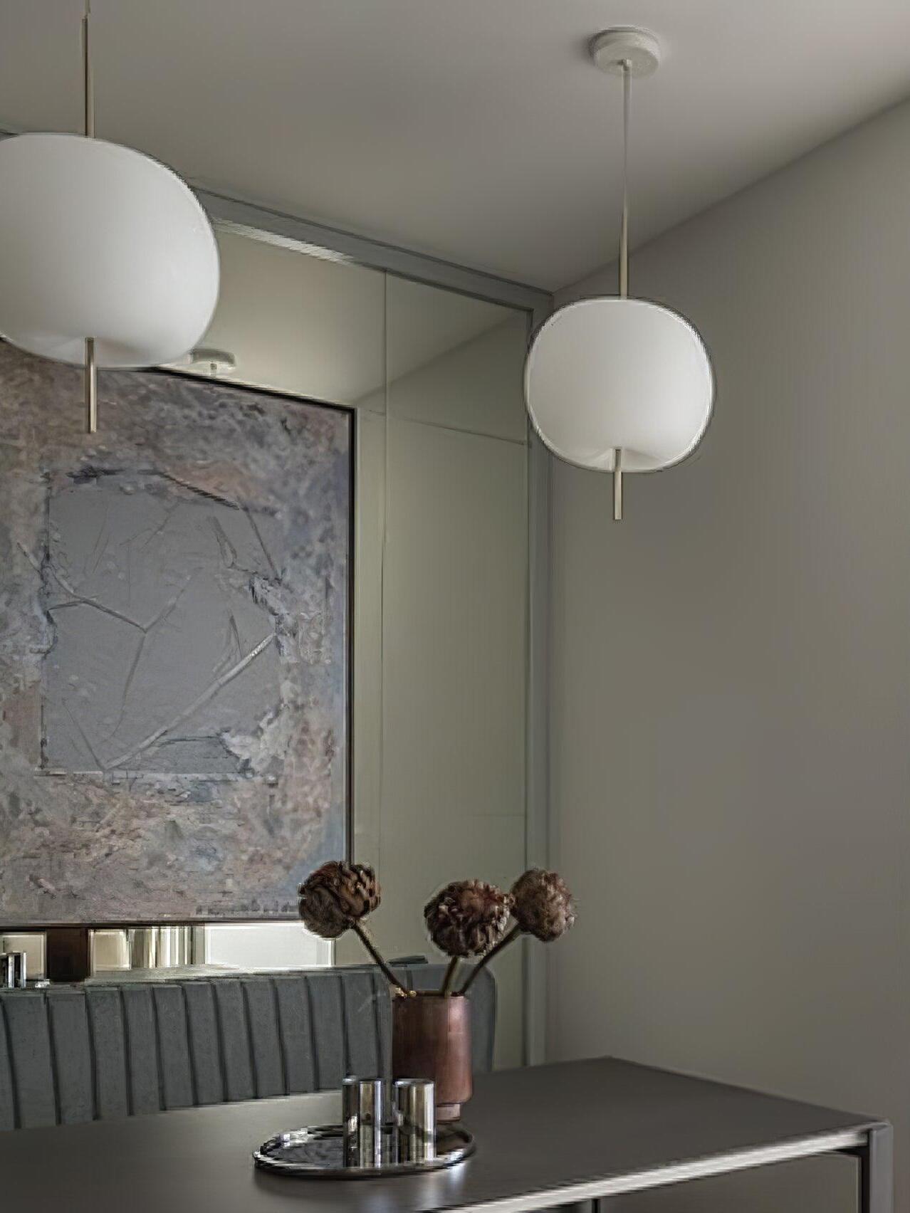 White glass pendant above a small dining table