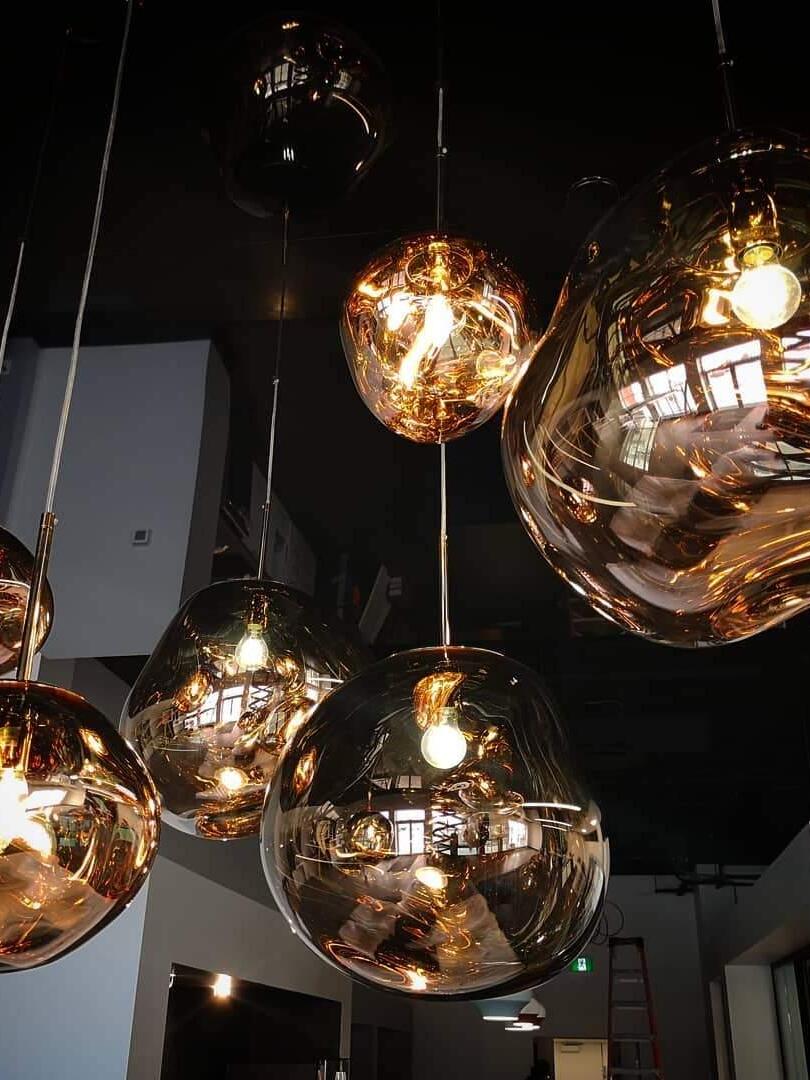 Gold-toned illuminated shades against a dark background