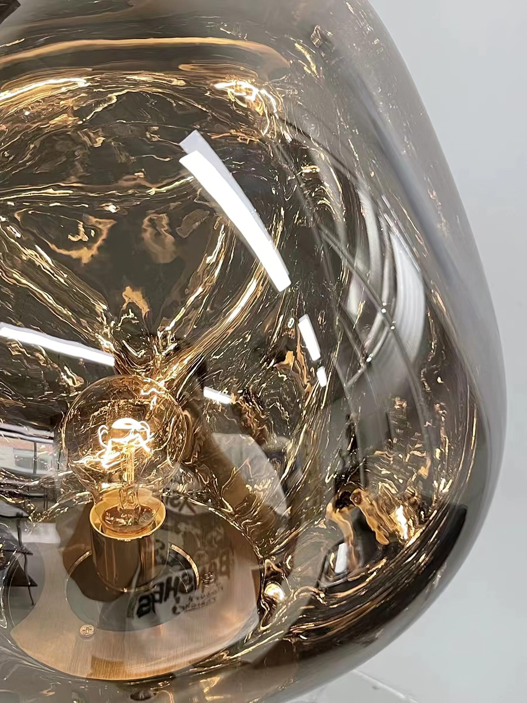 Bulb and socket visible through the irregular reflective globe, with ceiling reflections on the shade