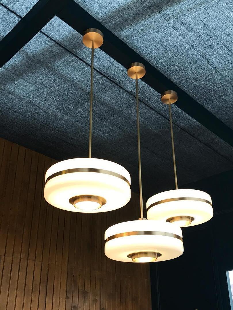 Three lit Masina pendants suspended at different heights