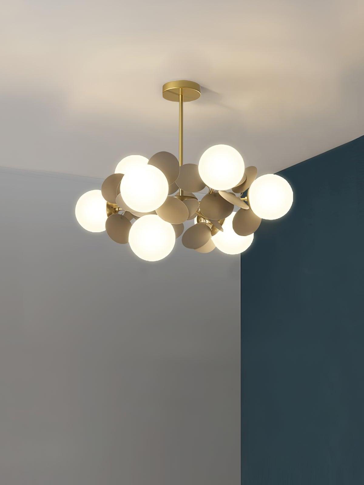 Gold chandelier with eight white globes and grey decorative discs